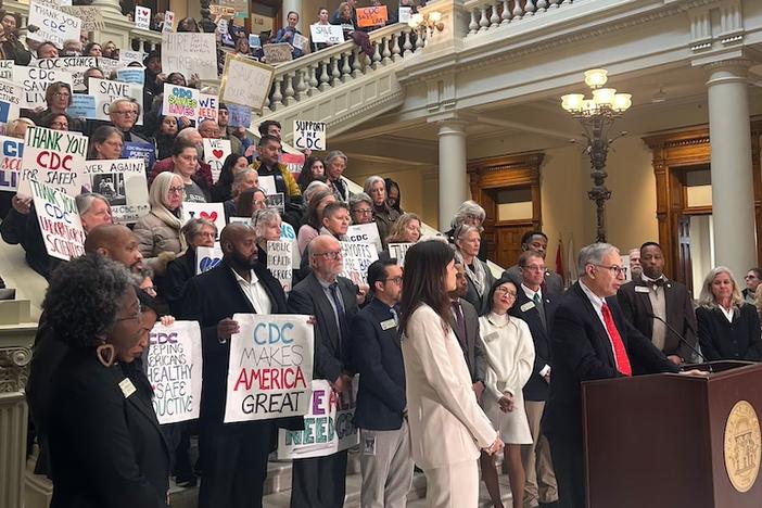 Workers who were laid off from the Centers for Disease Control and Prevention in Atlanta, and their supporters, speak at the Georgia Capitol on Friday. (Rebecca Grapevine / Healthbeat) 