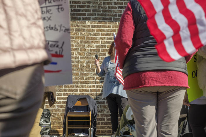 Since Representative Austin Scott was not at his Warner Robins district office, the nearly people who gathered there Monday to ask him questions about his support for President Trump’s agenda put their questions to an empty chair draped with a blue blazer. 