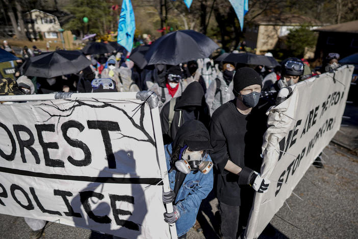 Protesters march during a demonstration in opposition to a new police training center, Monday, Nov. 13, 2023, in Atlanta.