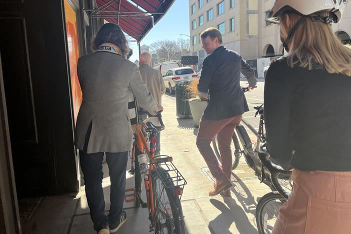 Cyclists travel through downtown to try out the new protected bike lane on March 11, 2025.