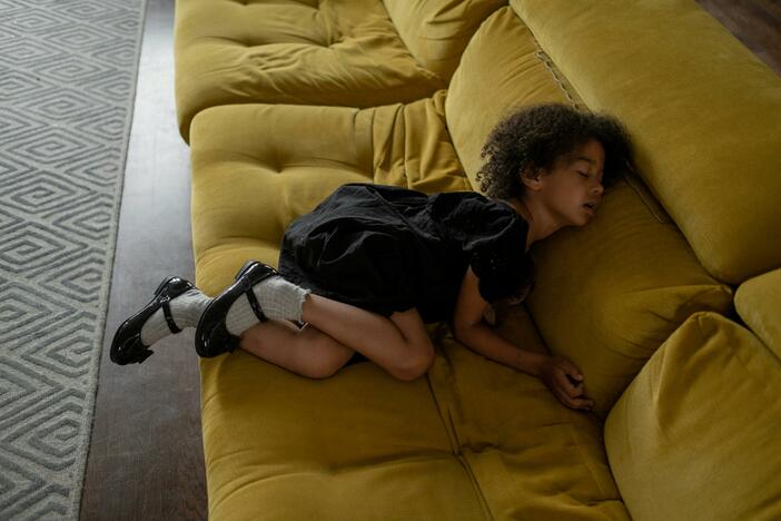 A girl sleeps on a sofa