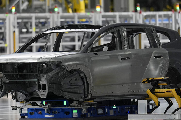 A Boston Dynamics robot works on the line during a media tour at the Hyundai Motor Group Metaplant America, Wednesday, March 26, 2025, in Ellabell, Ga. (AP Photo/Mike Stewart)