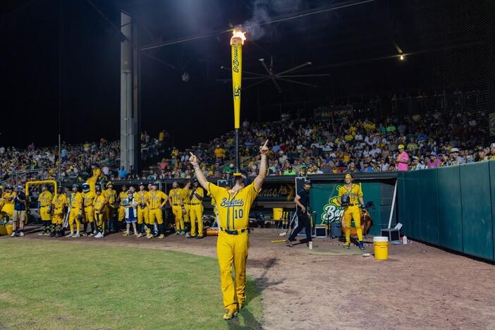 Savannah Banana Alex Ziegler balances a "torpedo bat" on his chin at Truist Park in Atlanta on March 31, 2025.