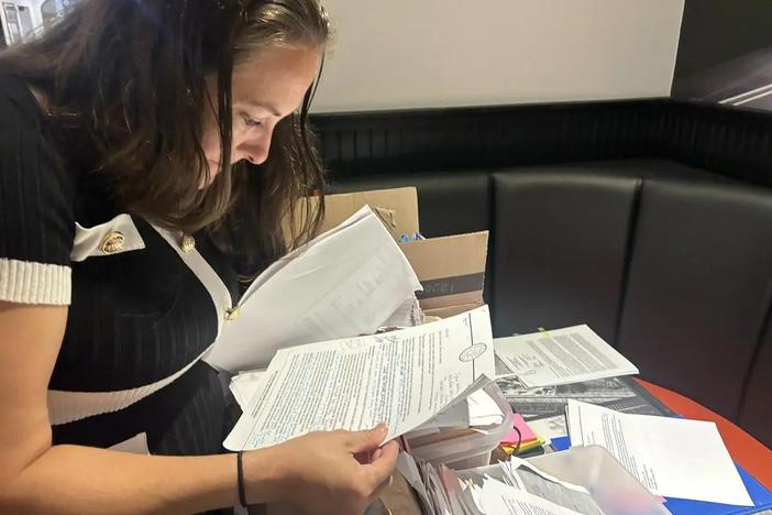 Kristen Clark-Hassell, of St. Marys, shows her voluminous files resulting from years of DFCS involvement in her children’s lives. (Jake Shore/The Current)