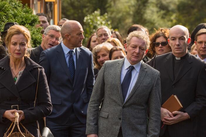 People in a funeral procession.