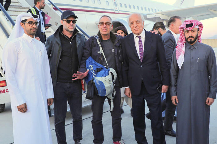 In this handout photo released by Qatar Ministry of Foreign Affairs, George Glezmann, center, poses with Adam Boehler, second left, and Zalmay Khalilzad, second right, and Qatari diplomats in Kabul, Afghanistan, Thursday, March 20, 2025, before departing to Doha, Qatar. 