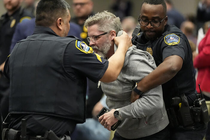 A protester is removed as Rep. Marjorie Taylor Greene, R-Ga., speaks during a town-hall style meeting, Tuesday, April 15, 2025, in Acworth, Ga.