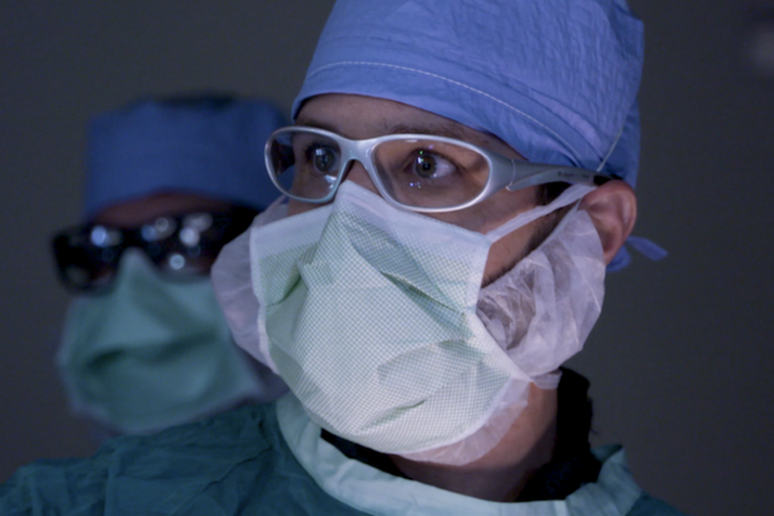 A masked surgeon.