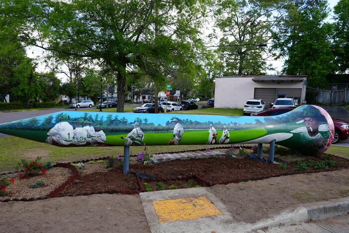 A mural depicting Augusta's Black caddies in Sand Hills.