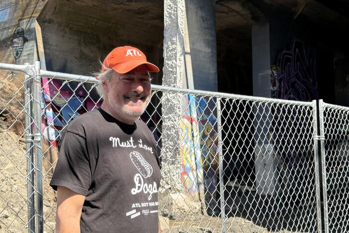 Adair Park resident Matthew Garbett stands on the Beltline in front of two light rail tunnels next to the path. 