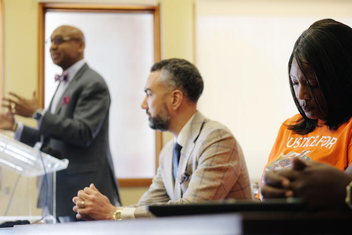 Paula Platt listens as attorney Muwali Davis speaks.