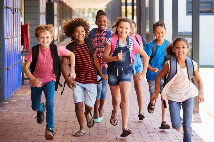 Students run in a school.