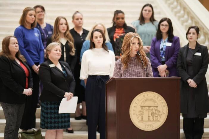 Heather Williams, center, at the Georgia State Capitol, with Rep. Lupton and other staff from assault centers in February 2024.