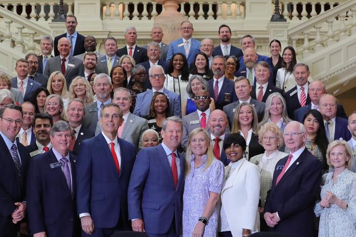 Gov. Brian Kemp signs bills into law inside the Georgia Capitol on May 8, 2025. Rep. Beth Camp is pictured among the lawmakers in attendance.