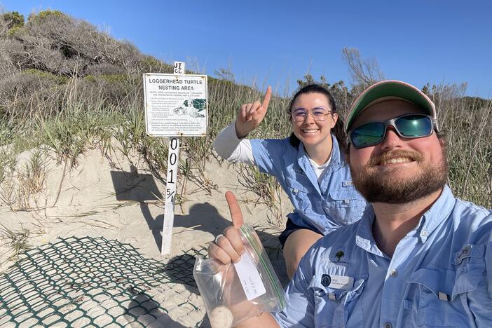 Jekyll Island Authority wildlife conservation technicians Bailey Yarborough and Will Hicks pose after finding Georgia's first sea turtle nest of the 2025 nesting season on May 1 along Glory Beach.