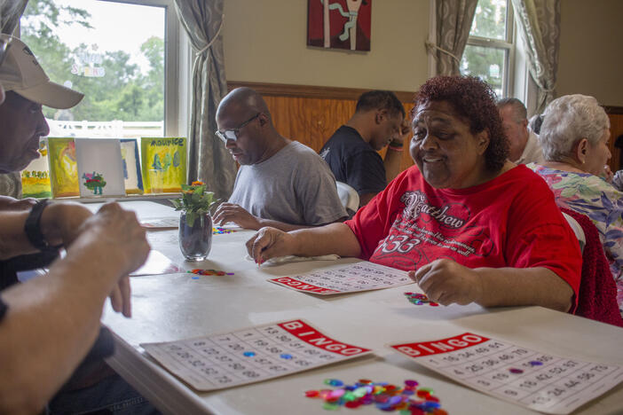 Patricia Cheeley, center, has been coming to Homeplace Adult Day Center in Wrens, G.a. for about five years. She's often found in the living room reading from her Bible. Cheeley and others who are elderly and/or disabled and eligible for Medicaid can use it to pay for long-term support services, like attendance to a day center.