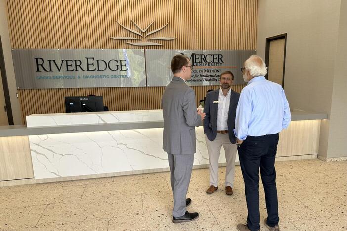Parrish Construction Group’s Charlie Griffis, center, speaks with architect Kamal Azar, right, and another visitor Thursday at the new River Edge Crisis Services and Diagnostic Center and Mercer University School of Medicine’s Center for IDD Care. (Liz Fabian/The Macon Newsroom)