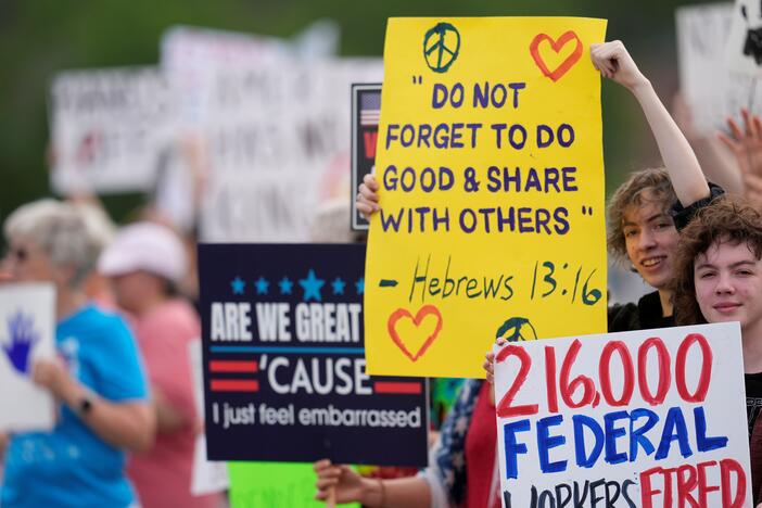 Civil rights demonstrators hold signs and speak to passing vehicles, Saturday, April 5, 2025, in Rome, Ga.