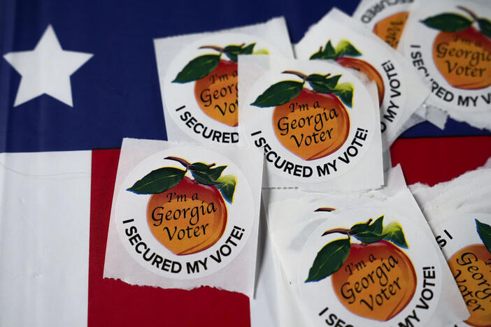 FILE - Stickers lay on a table inside a polling place, Tuesday, Nov. 5, 2024, in Atlanta. (AP Photo/Brynn Anderson, File)
