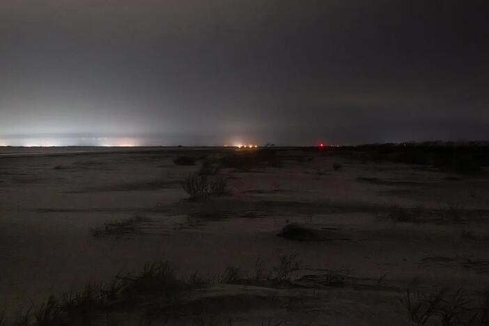 The lights (center horizon) from Exit 42, the location of the new Buc-ee’s, are seen 14 miles away on the beach of Sapelo Island on June 25, 2025. Credit: Justin Taylor/The Current GA/CatchLight Local