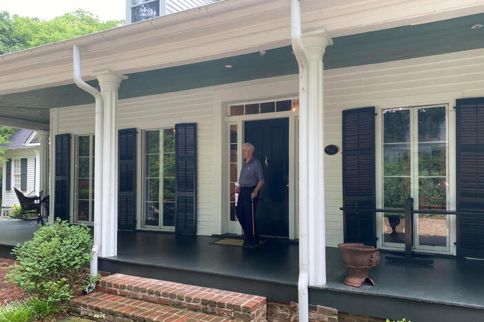 Charles Harrison standing on the front porch of his home in Atlanta East Lake