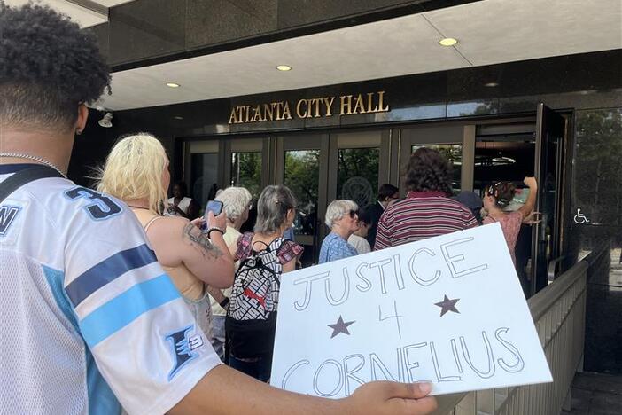 sign reads" justice 4 Cornelius" at Atlanta City Hall