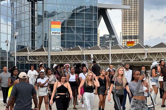 Beyoncé fans leave mercedes benz in western wear and a MARTA transit sign is visible in the back