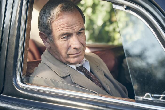 Geordie Keating (Robson Green) looking out of a car window.