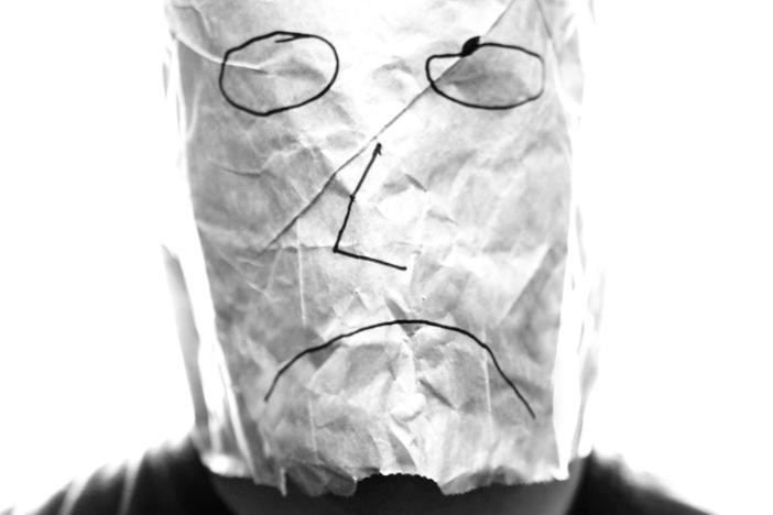 (Photo Courtesy of <a href=http://upload.wikimedia.org/wikipedia/commons/0/0d/Gray_paper_bag_with_sad_smiley_over_head.jpg>Saibo