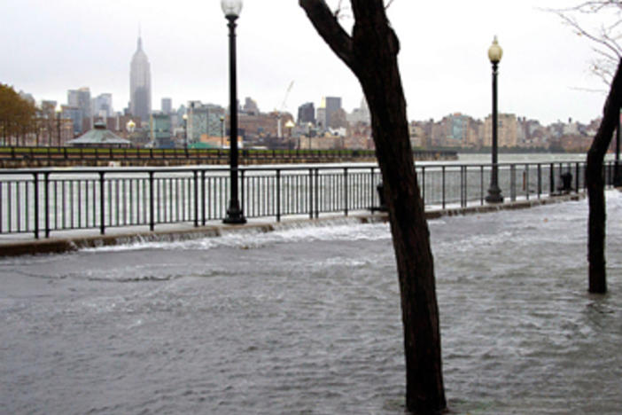 The Hudson River swells and rises over the banks of the Hoboken, NJ. Photo courtesy Charles Sykes/AP