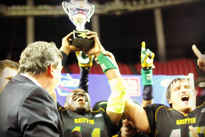 The Griffin Bears hoist the AAAA state championship trophy.