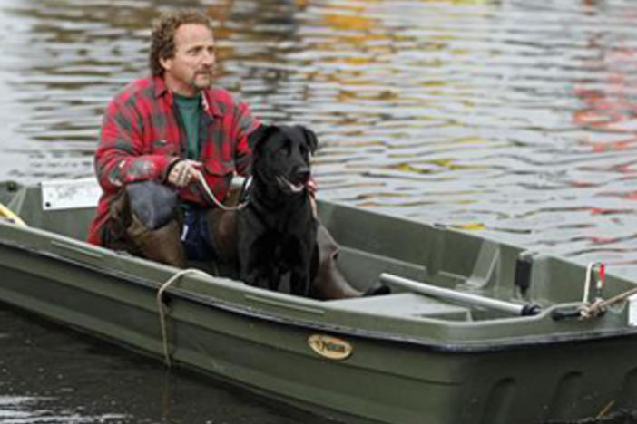 Ray Cilli and his dog Woubie are rescued from flood waters brought on by Hurricane Sandy in Little Ferry, New Jersey.