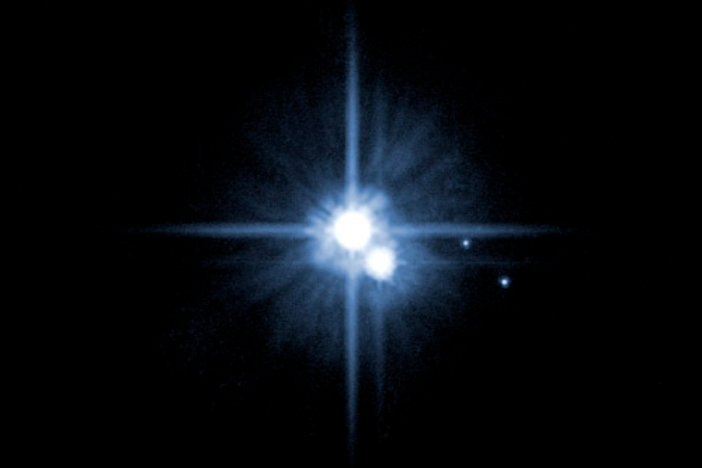 2005, then-new moons Nix and Hydra are the dots on the right. Credit: NASA, ESA, H. Weaver (JHU/APL), A. Stern (SwRI), HST Pluto
