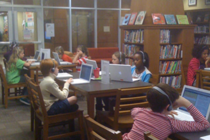 Students at 4/5 Academy measure their academic progress using programs on Macbooks.