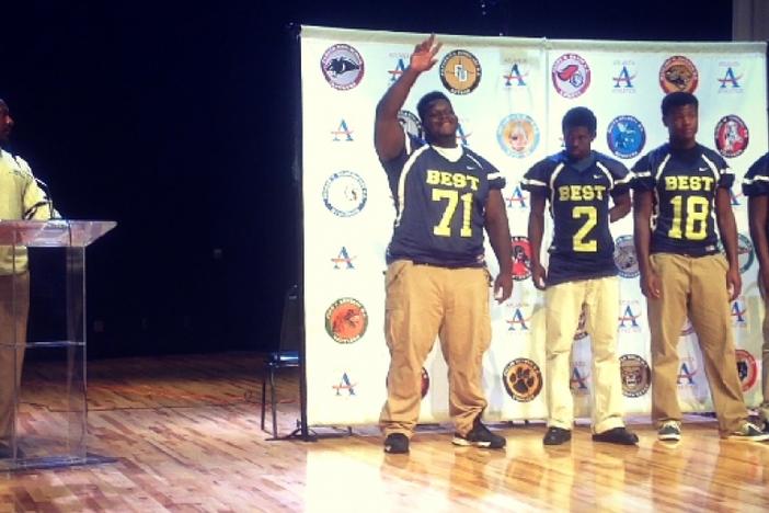 Head Coach Joshua Moore introduces senior defensive tackle/offensive guard Tyler Gibson at APS Media Day.