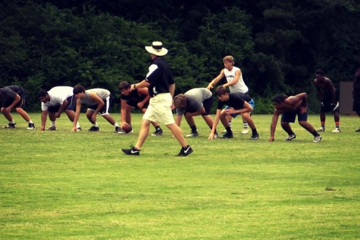 New Carrollton Head Coach Ed Dudley directs the action at a summer practice.