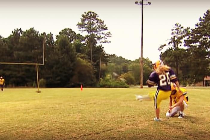 Taylor Tidaback attempts a field goal during football practice.
