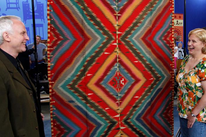 Douglas Diehl looks at a Navajo Germantown "Eye Dazzler" blanket, ca. 1885.