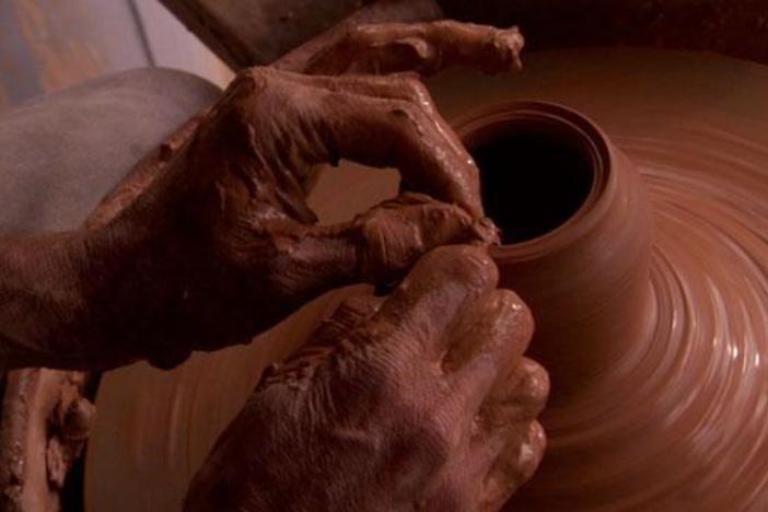 Ceramic artist David Gurney throws a small cup