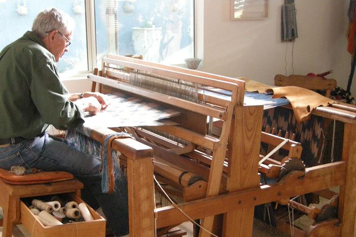 Jim Bassler weaving on the loom