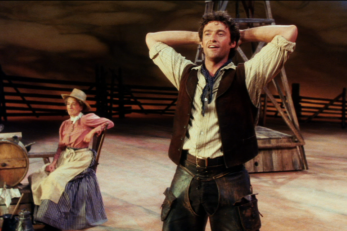 Hugh Jackman sings "Oh, What a Beautiful Mornin'" in a scene with Maureen Lipman.
