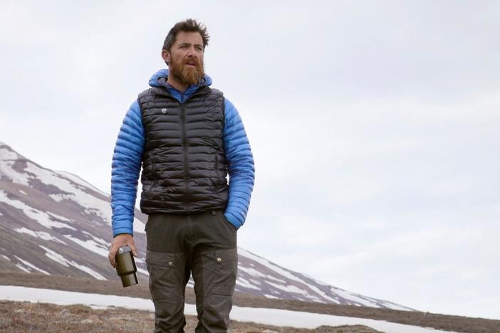 At the edge of camp, a muskox wanders the grounds.