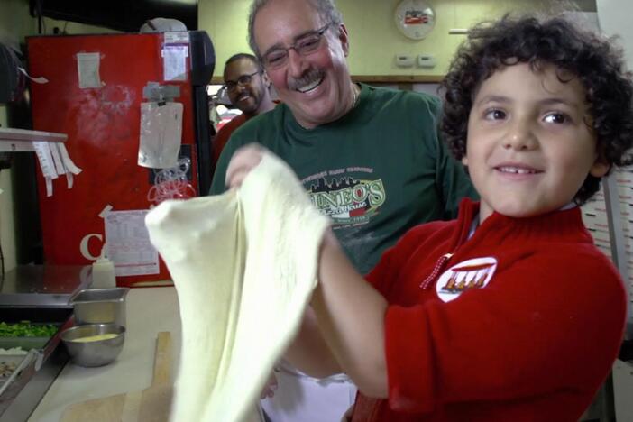 Phinneas learns how to make a pizza at a pizza parlor.