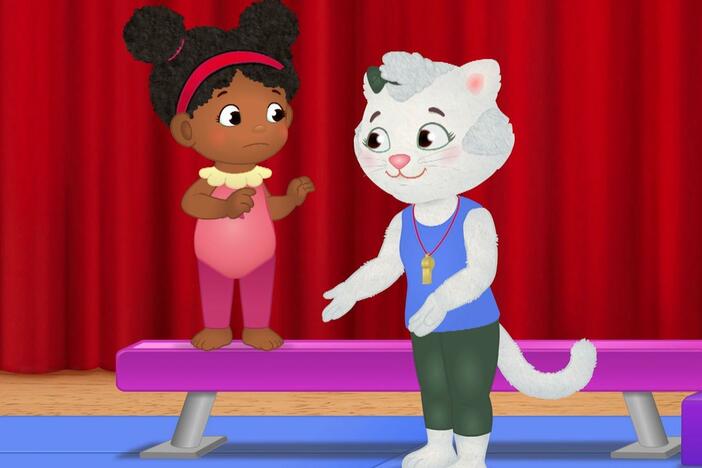Daniel and his friends try the balance beam at gymnastics class.