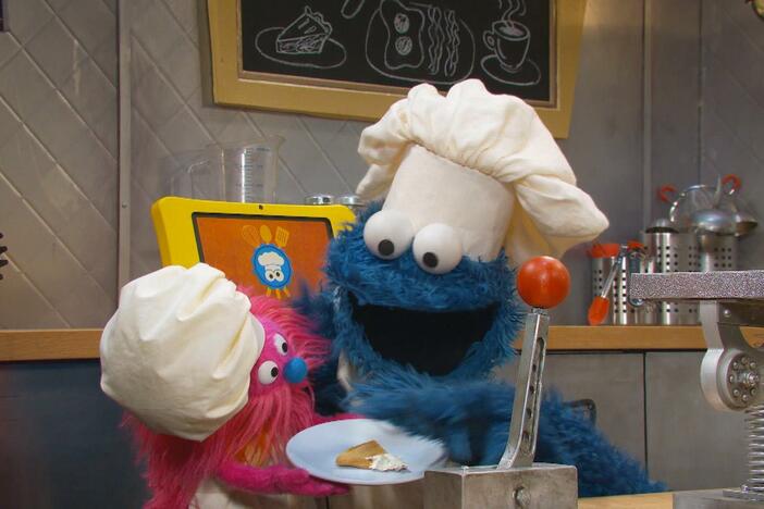 Cookie Monster and Gonger work together to make a Dino Dip Snack.