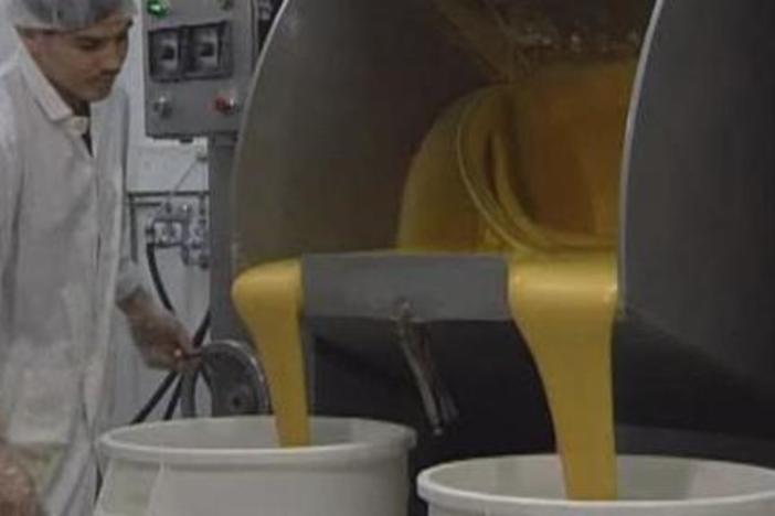 Watch how people make fortune cookies with flour, sugar, eggs, and water.