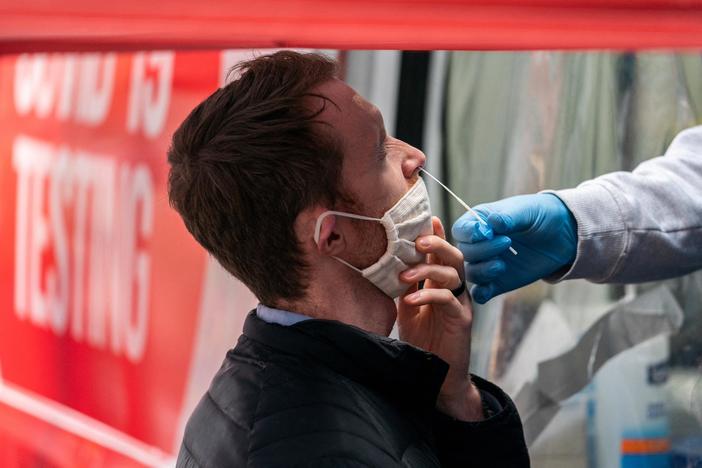 Vaccines reduce hospitalizations, but slow testing and rapid omicron spread worry experts