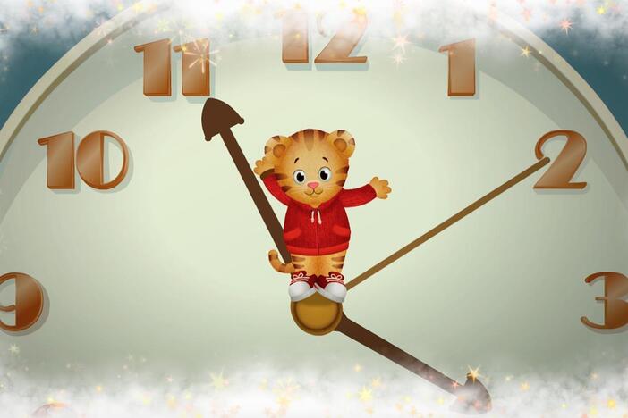 Daniel makes believe as he sings and plays inside a clock!  