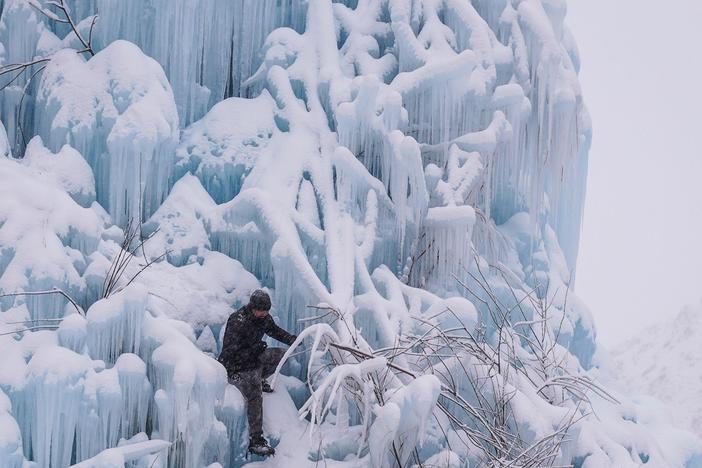 Mountain guides venture into a glacier high in the mountains to examine how fast it is melting.
