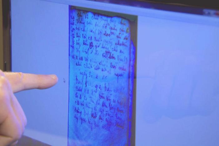 Wes Cowan talks with translator Merle Pribbenow, who translates passages from the diary.